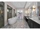 Luxurious bathroom with a standalone tub, double sinks, and marble floors at 9704 Milano Dr, Trinity, FL 34655