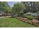 Welcoming Florencia community entrance with lush landscaping, colorful flowers, and an inviting entrance sign at 9704 Milano Dr, Trinity, FL 34655
