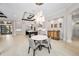 Spacious dining area with a modern table and access to the kitchen and outdoor spaces at 9704 Milano Dr, Trinity, FL 34655