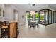 Bright dining area with views of the outdoor pool and comfortable seating at 9704 Milano Dr, Trinity, FL 34655
