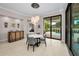 Stylish dining area with a modern light fixture and views of the pool area at 9704 Milano Dr, Trinity, FL 34655
