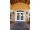 Close-up of glass doors with 'The Champions' Club' welcome mat in front at 9704 Milano Dr, Trinity, FL 34655