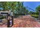 Grand entrance gate with brick paved driveway and stone pillars at Florencia at 9704 Milano Dr, Trinity, FL 34655