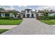 Charming home with a beautiful paver driveway, lush landscaping, and attached garages, perfect for comfortable living at 9704 Milano Dr, Trinity, FL 34655