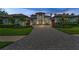 A stunning home featuring a paver driveway, manicured landscaping, and elegant design, perfect for luxurious living at 9704 Milano Dr, Trinity, FL 34655