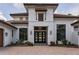 Elegant front door with beautiful architectural details and manicured landscaping, showcasing the home's curb appeal at 9704 Milano Dr, Trinity, FL 34655
