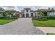 Elegant home with a beautiful paved driveway, manicured landscaping, and a grand entrance at 9704 Milano Dr, Trinity, FL 34655