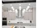 Close up view of the kitchen with stainless steel hood, mosaic backsplash, and pendant lighting at 9704 Milano Dr, Trinity, FL 34655
