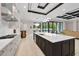 Spacious kitchen featuring a large island, modern appliances, and access to the outdoor pool area at 9704 Milano Dr, Trinity, FL 34655
