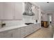 Detailed view of the kitchen with stainless steel hood and custom cabinets at 9704 Milano Dr, Trinity, FL 34655