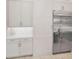 Well-lit kitchen featuring stainless steel refrigerator and ample white cabinets at 9704 Milano Dr, Trinity, FL 34655