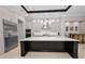 Kitchen showcasing stainless steel appliances, custom cabinets, and a dark center island at 9704 Milano Dr, Trinity, FL 34655