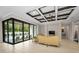 Bright living room features elegant ceiling design, tile floors, and sliding glass doors to the pool area at 9704 Milano Dr, Trinity, FL 34655