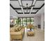 Spacious living room with elegant furniture, decorative ceiling, and sliding glass doors leading to the pool area at 9704 Milano Dr, Trinity, FL 34655