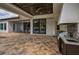 Spacious outdoor patio with dark wood ceiling, an outdoor kitchen and view of the pool with lounge chairs at 9704 Milano Dr, Trinity, FL 34655