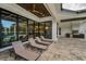 Beautiful patio with ceiling fan, lounge chairs, and outdoor kitchen, perfect for entertaining guests at 9704 Milano Dr, Trinity, FL 34655