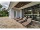 Relaxing patio with lounge chairs overlooking a sparkling pool, featuring a stylish wood ceiling and covered area at 9704 Milano Dr, Trinity, FL 34655