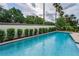 Well-maintained pool with lush green landscaping, providing a private oasis for relaxation at 9704 Milano Dr, Trinity, FL 34655