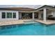 Beautiful pool and patio with outdoor kitchen, providing a perfect oasis for entertaining guests at 9704 Milano Dr, Trinity, FL 34655