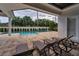 A view of the stunning pool area surrounded by lush greenery and lounge seating at 9704 Milano Dr, Trinity, FL 34655