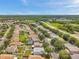 A high aerial view of a neighborhood, a road, and a patch of wetland at 9706 Simeon Dr, Land O Lakes, FL 34638