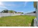 Large fenced backyard featuring well maintained lawn at 9706 Simeon Dr, Land O Lakes, FL 34638