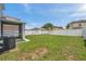 Fenced backyard featuring a well maintained lawn and covered patio at 9706 Simeon Dr, Land O Lakes, FL 34638