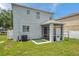 Spacious backyard with a screened in patio and white fencing at 9706 Simeon Dr, Land O Lakes, FL 34638