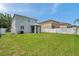 Spacious backyard with a screened in patio and white fencing at 9706 Simeon Dr, Land O Lakes, FL 34638