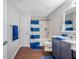 Well-lit bathroom featuring a tub, shower, blue vanity, and modern finishes at 9706 Simeon Dr, Land O Lakes, FL 34638