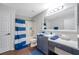 Bright bathroom with a tub, shower, blue vanity, and modern finishes at 9706 Simeon Dr, Land O Lakes, FL 34638