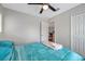 Well-lit bedroom featuring a ceiling fan, closet, and doorway with a comfortable bed at 9706 Simeon Dr, Land O Lakes, FL 34638