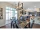 Dining area featuring sliding glass door, stylish light fixture, and view of the kitchen at 9706 Simeon Dr, Land O Lakes, FL 34638