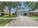 Charming two-story home with a two car garage, well-maintained lawn, and mature shade trees at 9706 Simeon Dr, Land O Lakes, FL 34638