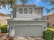 Two-story home featuring gray exterior paint, a gray roof and a two-car garage at 9706 Simeon Dr, Land O Lakes, FL 34638