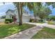 Charming two-story home with a two car garage, well-maintained lawn, and mature shade trees at 9706 Simeon Dr, Land O Lakes, FL 34638