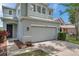 Charming two-story home with a two car garage and a well-maintained lawn and landscaped yard at 9706 Simeon Dr, Land O Lakes, FL 34638