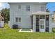 Back exterior of the house with view of the screened in patio and air conditioning unit at 9706 Simeon Dr, Land O Lakes, FL 34638