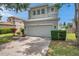 Charming two-story home with a two car garage and a well-maintained lawn and landscaped yard at 9706 Simeon Dr, Land O Lakes, FL 34638