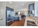 Beautiful kitchen with stainless steel appliances, island with breakfast bar, and view of living area at 9706 Simeon Dr, Land O Lakes, FL 34638