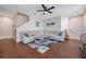 Well-lit living room featuring a white sectional couch, tile floors, and modern decor at 9706 Simeon Dr, Land O Lakes, FL 34638