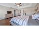 Large main bedroom showing tray ceiling, and wood-look flooring at 9706 Simeon Dr, Land O Lakes, FL 34638