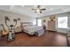 Spacious main bedroom boasts a tray ceiling, wood-look floors, and a ceiling fan at 9706 Simeon Dr, Land O Lakes, FL 34638