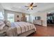 Bright main bedroom with wood-look floors, large windows, and access to a walk-in closet at 9706 Simeon Dr, Land O Lakes, FL 34638