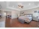 Large main bedroom features wood-look floors, neutral paint, and access to flex space at 9706 Simeon Dr, Land O Lakes, FL 34638