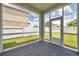 A screened in patio with an outside door and view of the fenced backyard at 9706 Simeon Dr, Land O Lakes, FL 34638