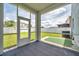 A screened in patio with an outside door and view of the fenced backyard at 9706 Simeon Dr, Land O Lakes, FL 34638