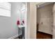Powder room with a round mirror, white sink, and modern fixtures at 9706 Simeon Dr, Land O Lakes, FL 34638