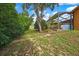 Exterior view of the home showing the backyard and screened pool area at 10924 Archway Ave, Hudson, FL 34667