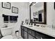 Chic bathroom featuring a vanity with black cabinetry and marble countertops at 10924 Archway Ave, Hudson, FL 34667
